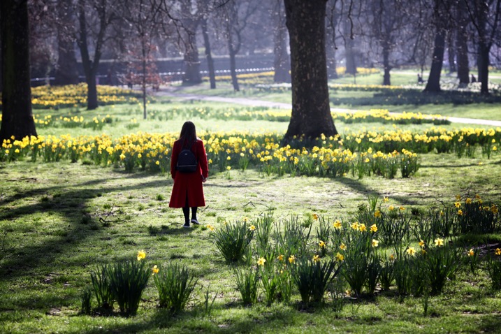 woman walking through a garden