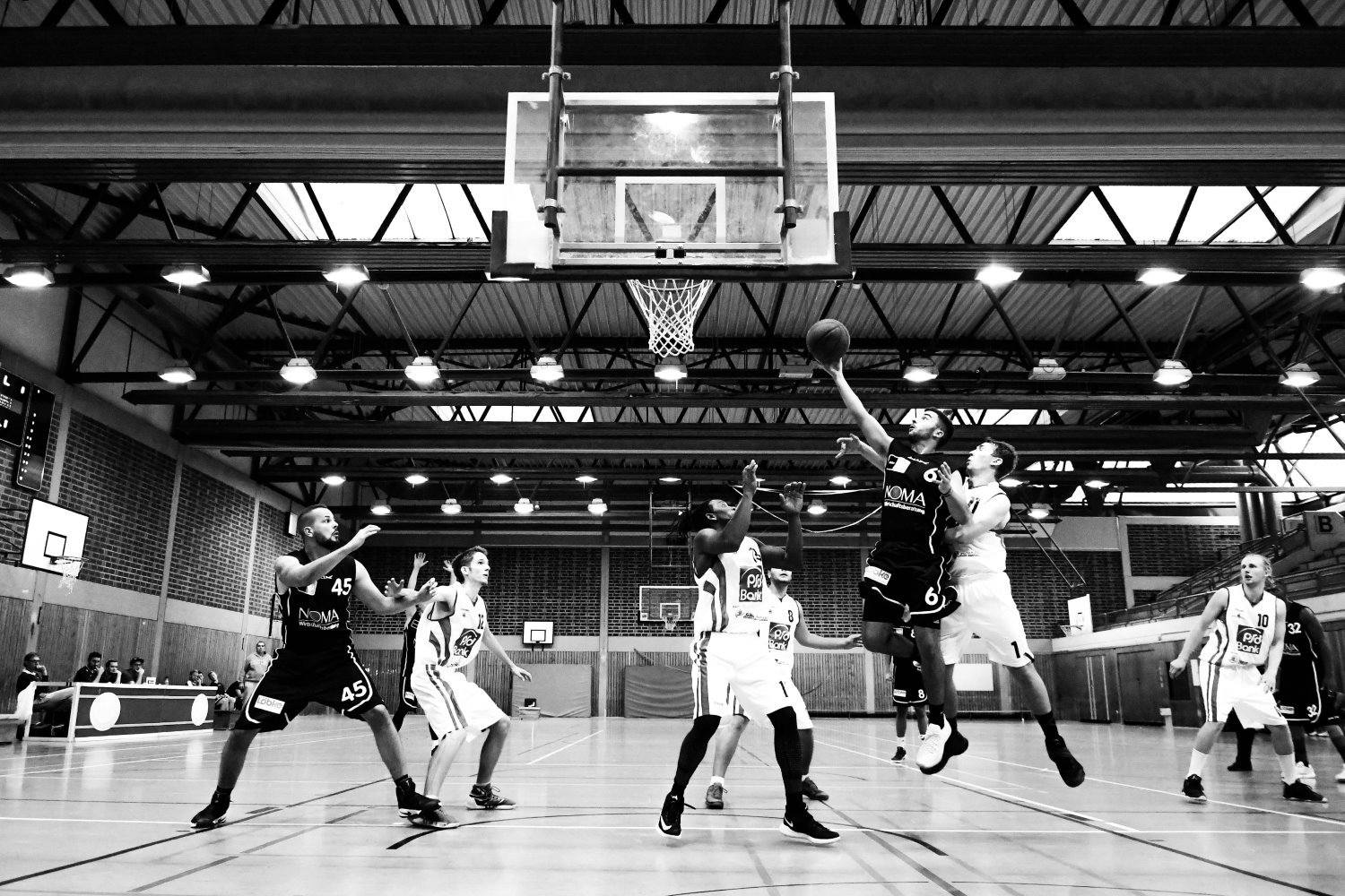 players playing basketball in black and white